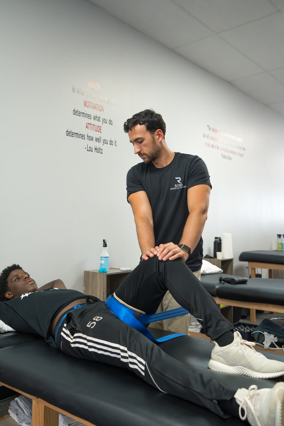 Therapist performing hands-on treatment with a patient lying on a treatment table