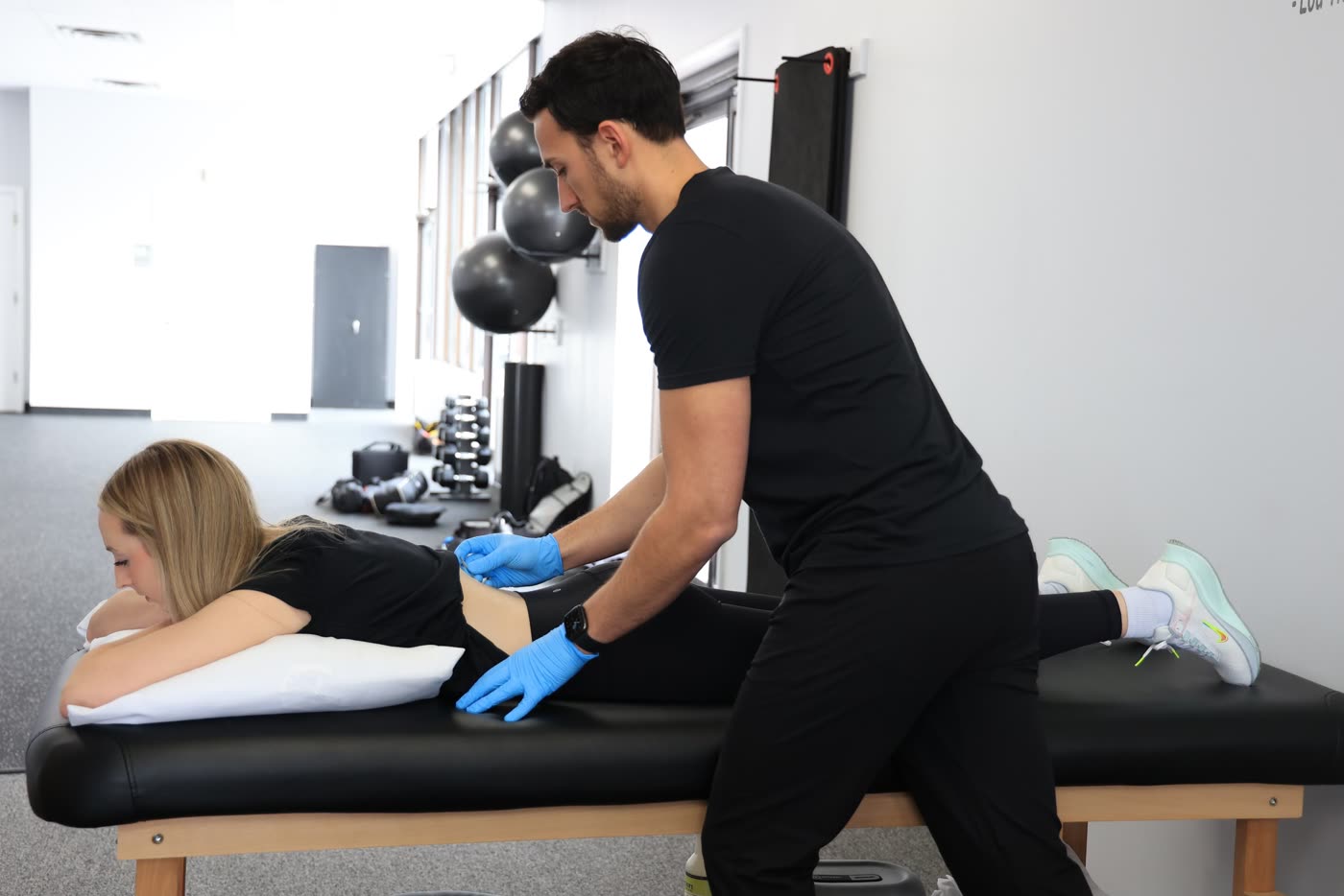 Therapist treating a patient on a treatment table